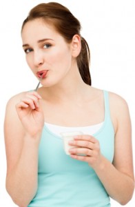 young-woman-eating-yogurt-196x300